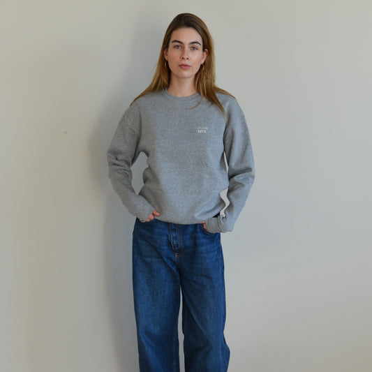 Stylish gray crewneck sweater providing comfort and cozy fit, perfect for any casual occasion.