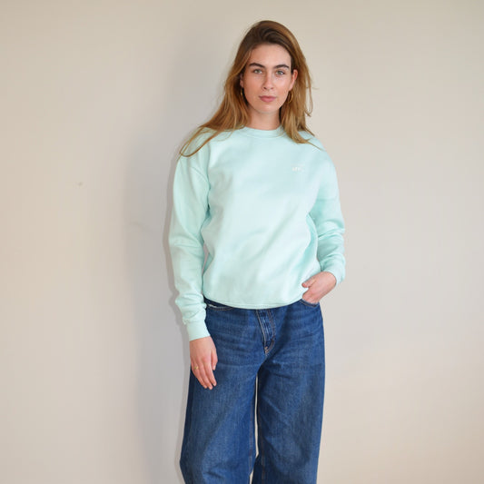 Model wearing The Essential Crewneck in mint, showcasing relaxed fit and stylish design for every occasion.